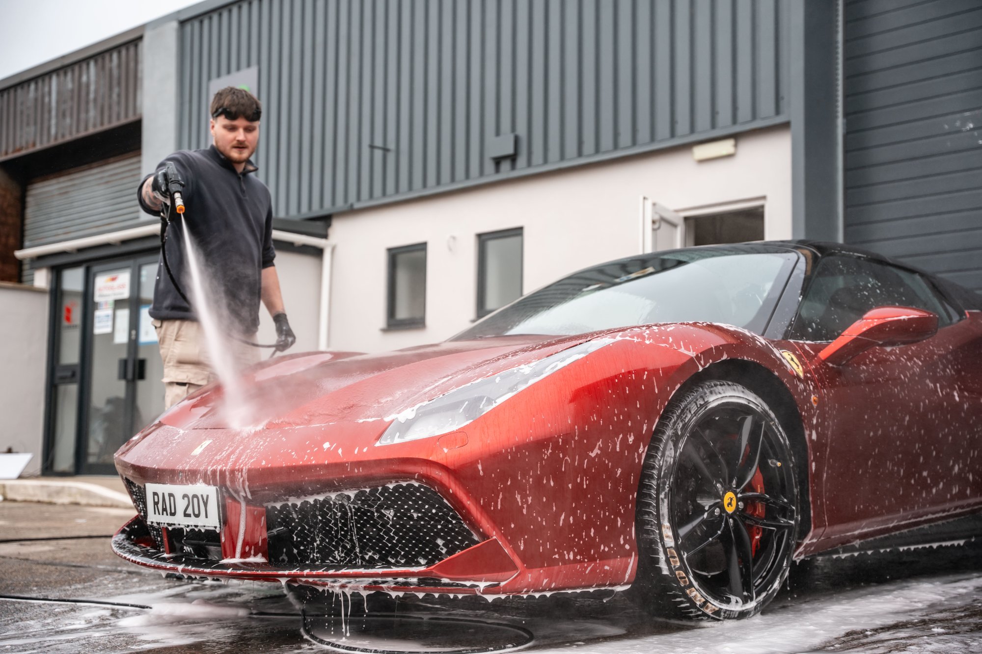 Ethan snow-foaming a Ferrari outside the Clean Cut unit in Douglas